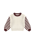 White sweater with maroon striped sleeves 