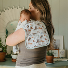 woman holding baby with a cowboy print burp cloth