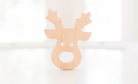 reindeer grasping wooden toy